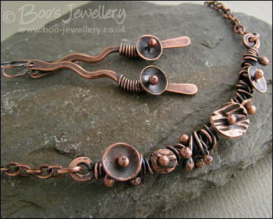 Copper necklace wrapped with buds and simple flower shapes