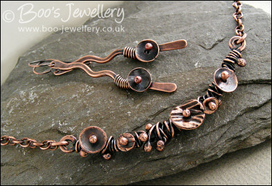 Copper necklace wrapped with buds and simple flower shapes