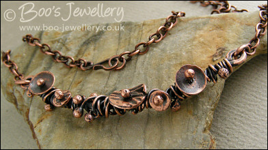 Copper necklace wrapped with buds and simple flower shapes