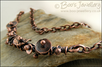 Copper necklace wrapped with buds and simple flower shapes