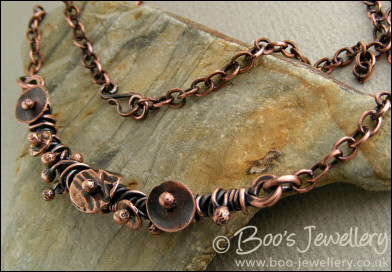 Copper necklace wrapped with buds and simple flower shapes