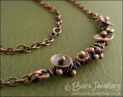 Copper necklace wrapped with buds and simple flower shapes