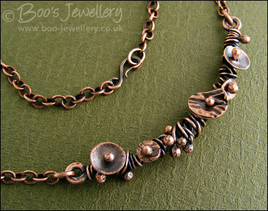Copper necklace wrapped with buds and simple flower shapes
