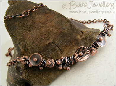 Copper necklace wrapped with buds and simple flower shapes