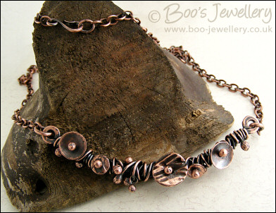 Copper necklace wrapped with buds and simple flower shapes