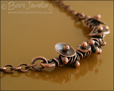 Copper necklace wrapped with buds and simple flower shapes