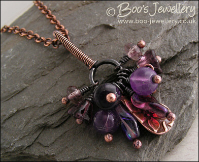 RESERVED - Antiqued copper pendant necklace clustered with purple and copper charms