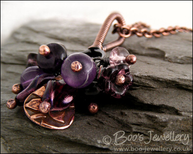 RESERVED - Antiqued copper pendant necklace clustered with purple and copper charms