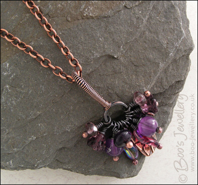 RESERVED - Antiqued copper pendant necklace clustered with purple and copper charms