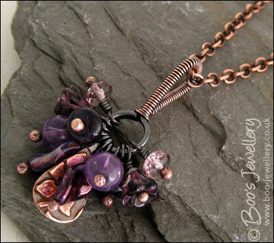 RESERVED - Antiqued copper pendant necklace clustered with purple and copper charms