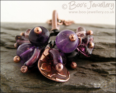 RESERVED - Antiqued copper pendant necklace clustered with purple and copper charms