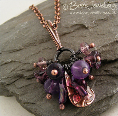 RESERVED - Antiqued copper pendant necklace clustered with purple and copper charms