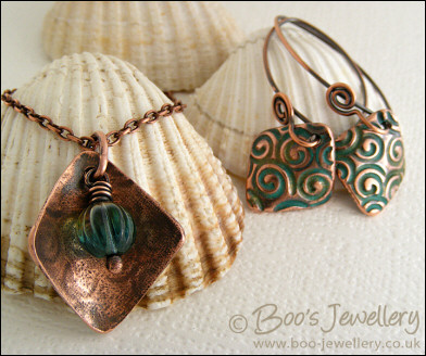 Necklace and earring set  with copper charms impressed with turquoise spirals