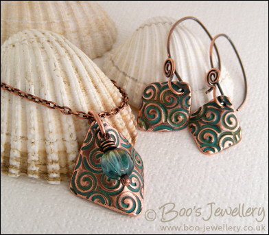 Necklace and earring set  with copper charms impressed with turquoise spirals
