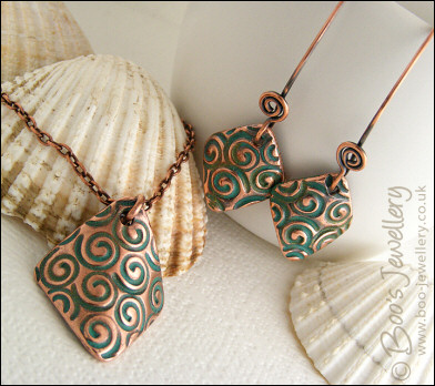 Necklace and earring set  with copper charms impressed with turquoise spirals