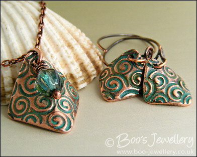 Necklace and earring set  with copper charms impressed with turquoise spirals