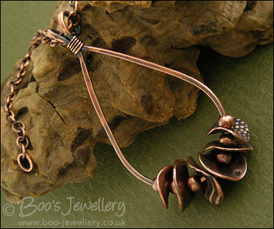 Teardrop loop pendant with textured copper washers