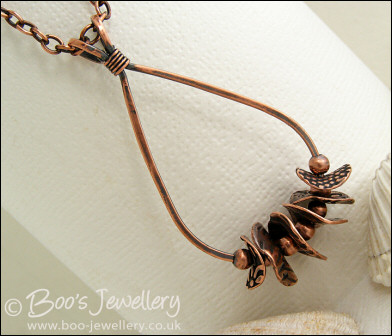 Teardrop loop pendant with textured copper washers