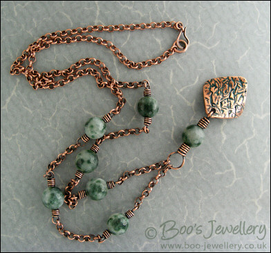 Copper and green jade necklace and earring set with crackled charms