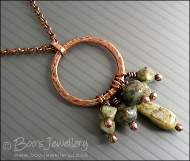 Necklace and earring set featuring a hammered circle wrapped with earthy beads