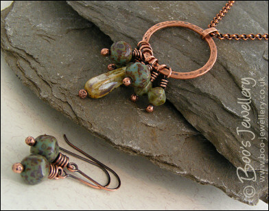 Necklace and earring set featuring a hammered circle wrapped with earthy beads