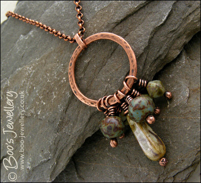 Necklace and earring set featuring a hammered circle wrapped with earthy beads