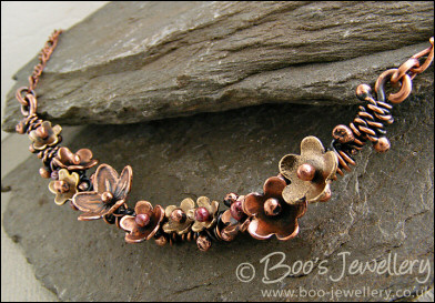 Copper and bronze necklace wrapped with buds and flowers