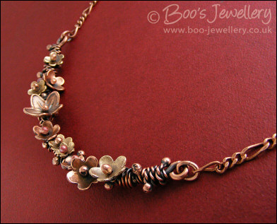 Copper and bronze necklace wrapped with buds and flowers