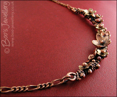 Copper and bronze necklace wrapped with buds and flowers
