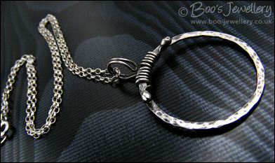 Hammered silver circle pendant with tendril bail