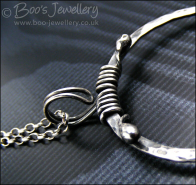 Hammered silver circle pendant with tendril bail
