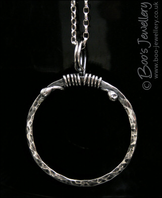 Hammered silver circle pendant with tendril bail