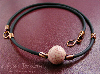 Ceramic bead, copper coils and black necklace