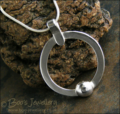 Hammered silver circle pendant with silver pebble