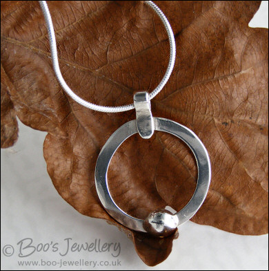 Hammered silver circle pendant with silver pebble