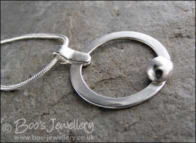 Hammered silver circle pendant with silver pebble