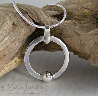 Hammered silver circle pendant with silver pebble
