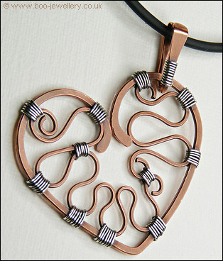 Hammered copper heart with silver wrapping on a chain
