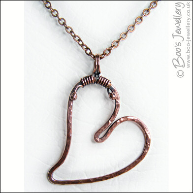 Hammered copper heart pendant with tendril bail